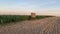 Lookout tower between corn field and empty field