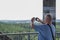 Lookout tower man take picture smartphone summer closeup view tourism travel