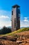 The lookout tower on Mount Medvedi stands on the mountain hiking trail in High Jesenik, on a sunny day