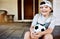 He looks forward to soccer practice. a little boy sitting on the porch with his soccer ball.