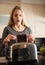 Looks like its going to be one of those days. Shot of a young woman removing a slice of burnt toast from a toaster at