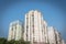 Lookup typical condos with hanging clothes over blue sky in Hanoi, Vietnam