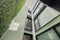 Lookup view of modern residential building with vertical gardening in Barcelona. Black frame windows and green walls.