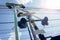 Lookup view of railroad crossing sign with stop lights of semaphore, electric wire under bright blue sky