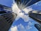 Lookup view of variety of corporate business high-rise skyscrapers buildings with blue bright sky in a downtown