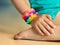 Loom bracelets on child hand close up.Rubber colorful wrist accessories.