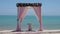 Loopable Cinemagraph of Pink Wedding Arch on Sandy Beach Beside the Sea