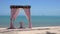 Loopable Cinemagraph of Pink Wedding Arch on Sandy Beach Beside the Sea