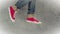 Loopable Stop Motion Animation of Young Person in Jeans and Red Sneakers Running
