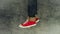 Loopable Stop Motion Animation of Young Person in Jeans and Red Sneakers Walking