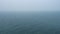 Looped video. Thick fog over calm water surface.