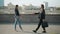 Looping of businesspeople man and woman walking outdoors shaking hands greeting