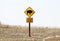 Loose Bison with picture of animal caution sign stands surrounded by winter grass on the Tall Grass Prairie in Oklahoma USA