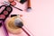 Loose face powder, brush and various cosmetic decorative makeup products on a pink background. Close up. Makeup brush and