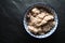 Loose pearl barley in a bowl on a gray stone