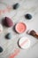 Loose rouge make-up powder with blender, sponge and brush on marble beauty table