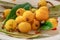 Loquats fruits with green leaves on plate close up