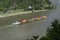 Loreley, Germany - 25 July 2021. A large barge carrying a lot of containers on the Rhine River in western Germany, visible hills o