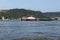 Loreley, Germany - 25 July 2021. A large barge on the river Rhine in Germany for the transport of coal or aggregate. Large warehou