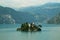 Loreto island in the middle of the Iseo lake with hills in the background