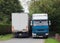 Lorries meeting on a narrow road.