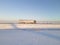 Lorry truck on the road surrounded by winter fields