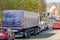 Lorry truck stuck in busy traffic on road in british town at noon time