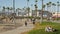 LOS ANGELES CA USA - 16 NOV 2019: California summertime ocean Venice beach aesthetic, many people walking and ride