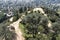 LOS ANGELES, CALIFORNIA - 12 FEB 2020: Hikers on a trail seen from the Griffith Park Observatory with the city beyond