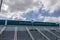 The Los Angeles Convention Center with a staircase, lush green trees, blue sky and clouds in Los Angeles California