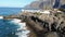 Los Gigantes cliffs and overlooking the ocean from the beach. Morning on the island of Tenerife. Atlantic waves and volcanic beach