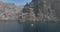 Los Gigantes steep huge cliffs rock wall bordering the blue atlantic ocean panorama seascape aerial drone footage