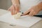 Ð¡lose photo of the hands of woman who is cutting butter on a board with a knife