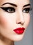 Ð¡lose-up portrait of a woman with red lips and black make-up look away