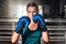 Ð¡lose up view of girl in boxing gloves training at gym. Young woman boxing in the gym