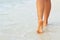 Ð¡lose up of woman leg on the beach. Woman  feet walking on the sand. Foot female.