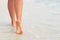 Ð¡lose up of woman leg on the beach. Woman  feet walking on the sand. Foot female.Skin Care.