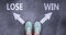 Lose and win as different choices in life - pictured as words Lose, win on a road to symbolize making decision and picking either