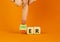 Loser or leader symbol. Businessman turns wooden cubes and changes the word Loser to Leader. Beautiful orange table orange