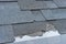 Ð¡loseup view of asphalt shingles roof damage that needs repair.