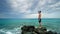 Lost alone male teen standing on sea rock