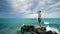 Lost alone male teen standing on sea rock