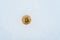 The lost coin of crypto-currency in winter in the snow. Gold bitcoin in the snow alone.