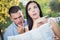 Lost and Confused Mixed Race Couple Looking Over Map Outside