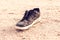 Lost dirty shoe on ground in the street. Poverty concept