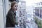 Lost and sad woman at home balcony suffering depression looking thoughtful and solitary