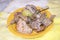 a lot of assorted boiled meat duck turkey mutton rabbit on a yellow plate