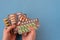 A lot of blisters with different pharmaceutical medicine pills in hands. Multicolored tablets, pills and capsules in foil packages