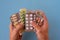 A lot of blisters with different pharmaceutical medicine pills in hands. Multicolored tablets, pills and capsules in foil packages