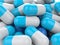 A lot of blue medicine capsule pills - closeup shot